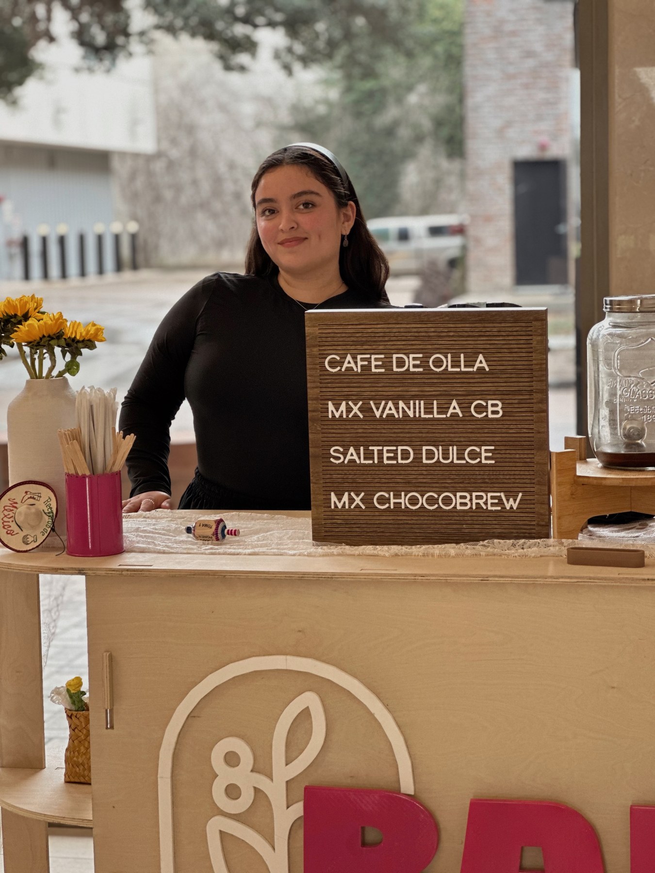 Raíz barista behind the Mexican-inspired coffee cart at an event